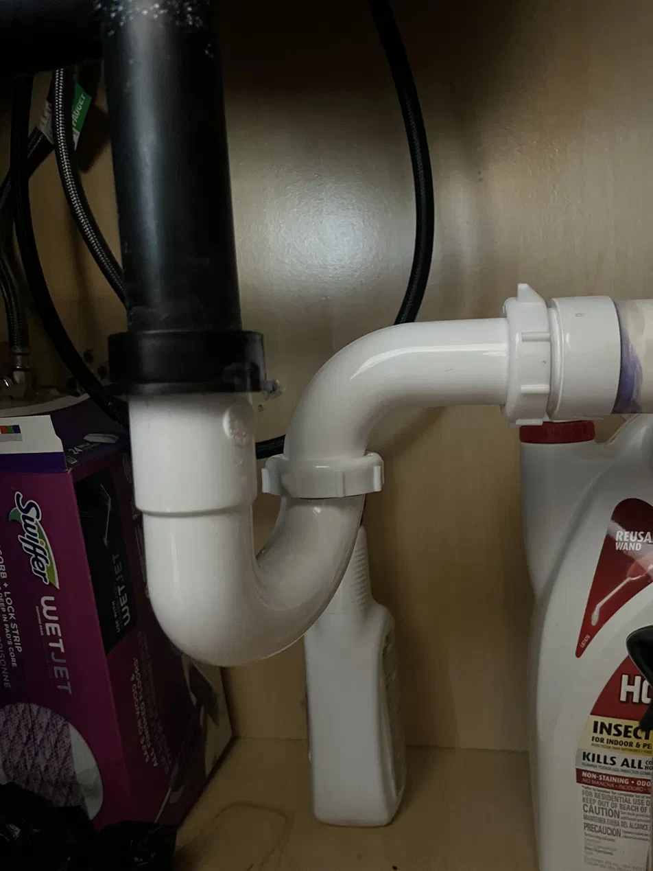 Repaired P-trap plumbing under a sink